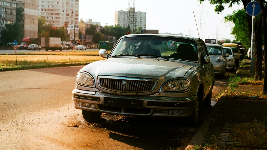 two cars are parked side by side on a dirty street