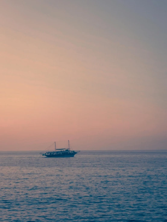 a small fishing boat in the middle of calm water