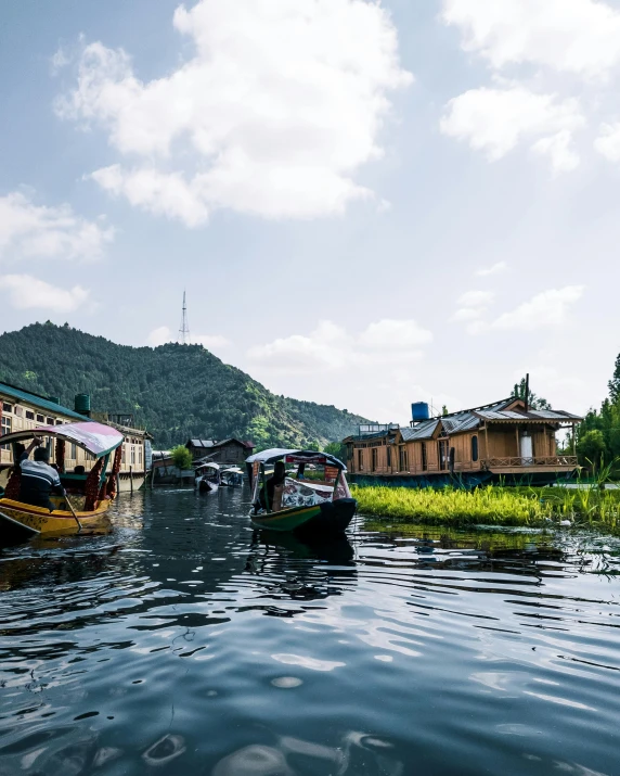 a river with boats in the water and houses on shore