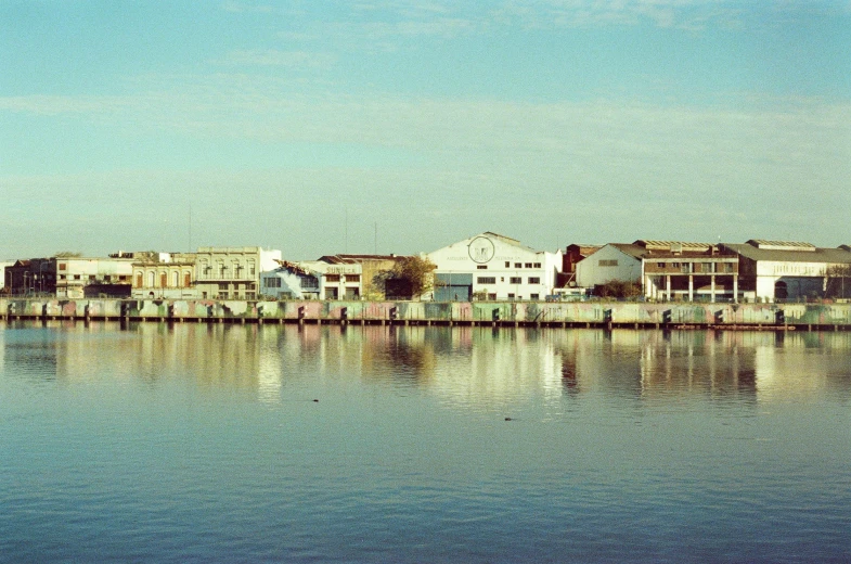 a row of houses sits across a harbor