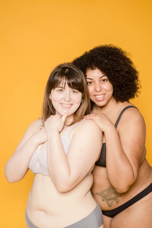 a couple of young ladies posing for a po