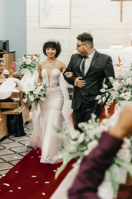 a bride and groom walk down the aisle at a wedding