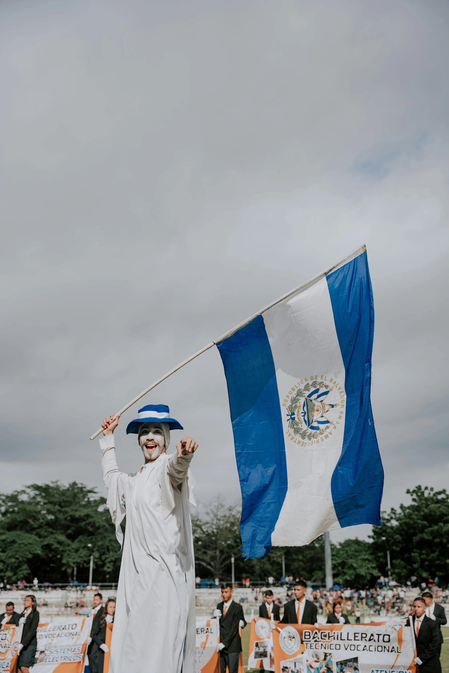 a person with white hair holding a flag