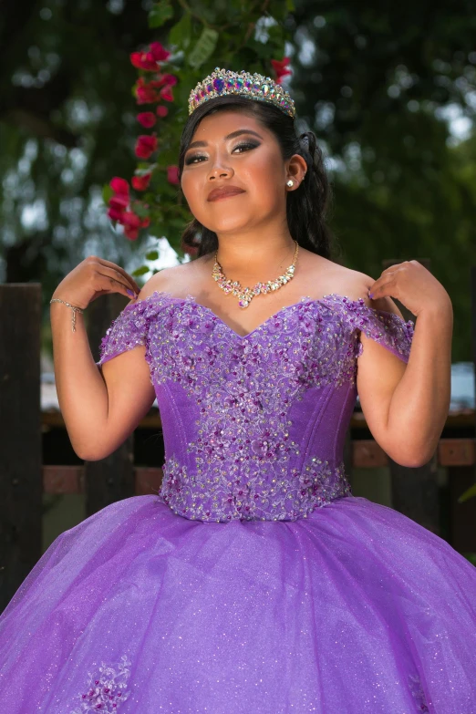 a young african american girl in a purple gown