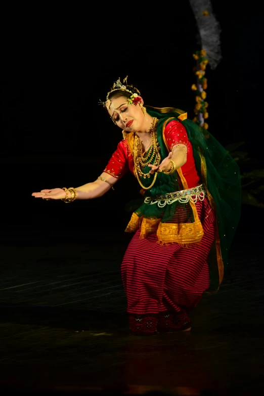 a woman in an indian dance style in a stage setting