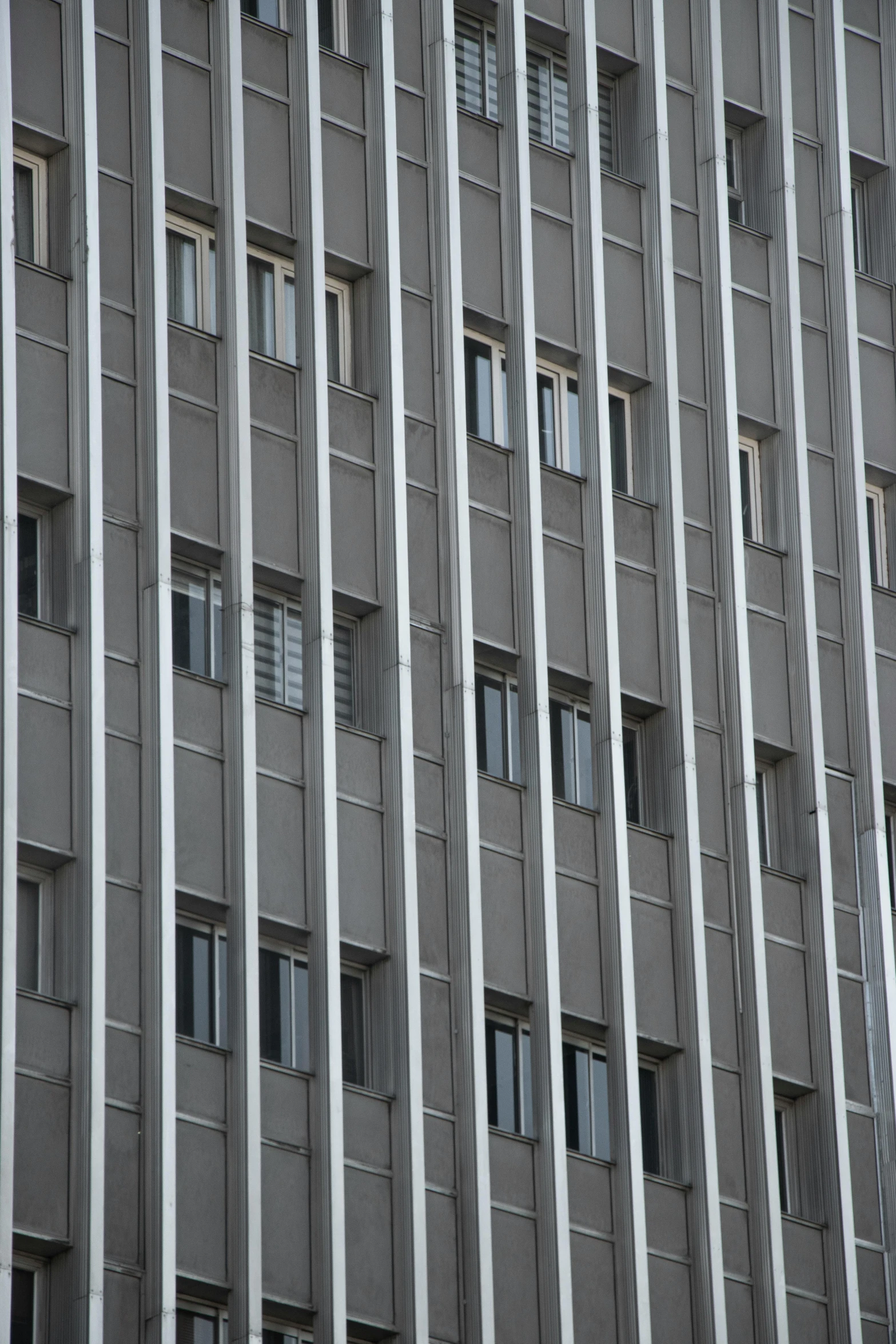 an apartment building with many windows and a stop sign