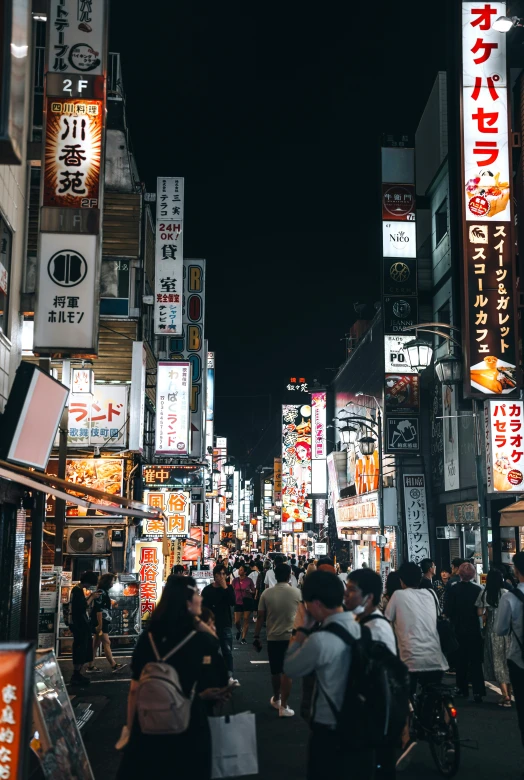 a street in japan that has signs and lights all around