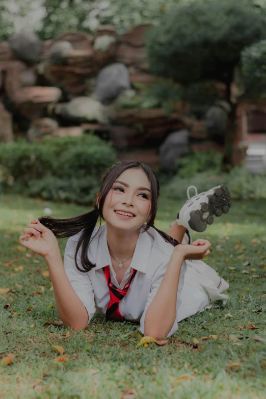 a young woman in a white shirt holding up a pair of black shoes