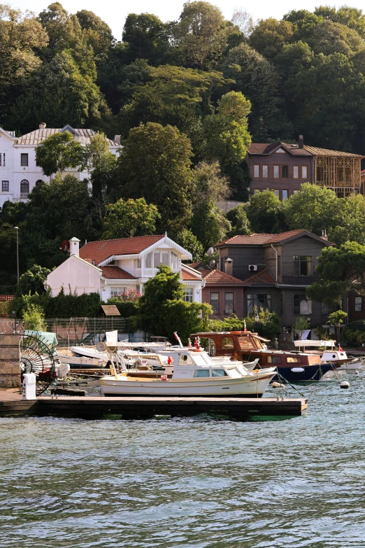 there is a dock next to the sea with many boats