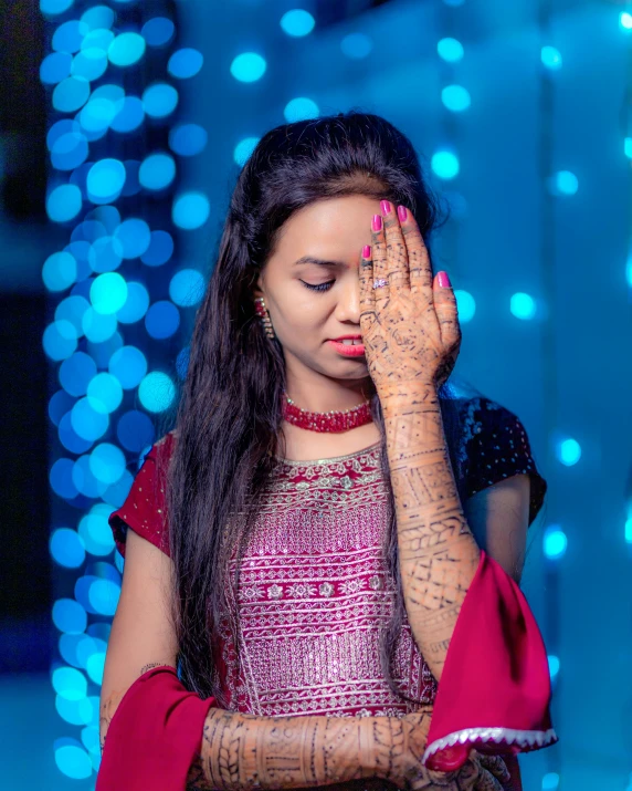 a woman covered with hendi is praying