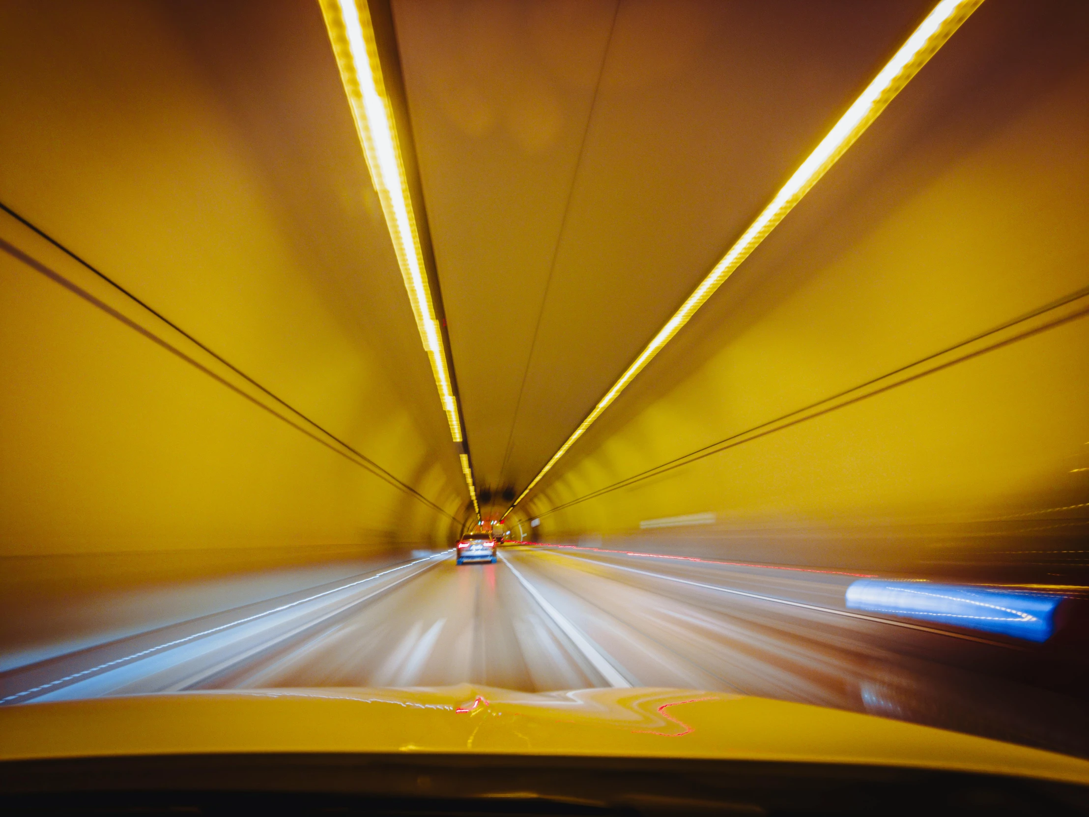 an image of a car driving through the tunnel