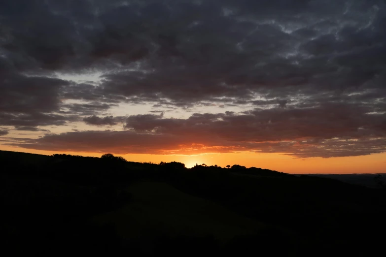 a sunset view of a rural countryside and clouds