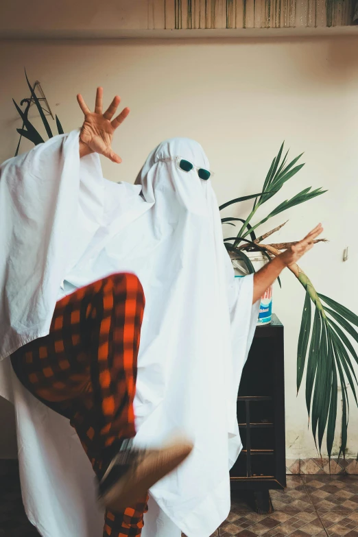 a person is dressed up like a ghost in plaid clothes