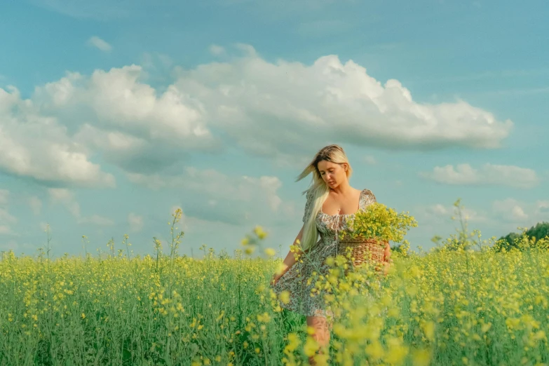 a woman holding a basket in a field full of flowers