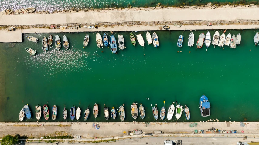 an aerial po of people, boats and surfboards docked