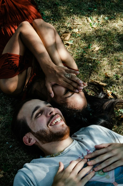 a young man lies next to a woman