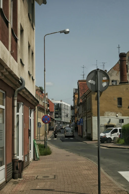 a red brick road with a clock on the corner