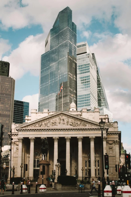 a building stands in front of some tall buildings