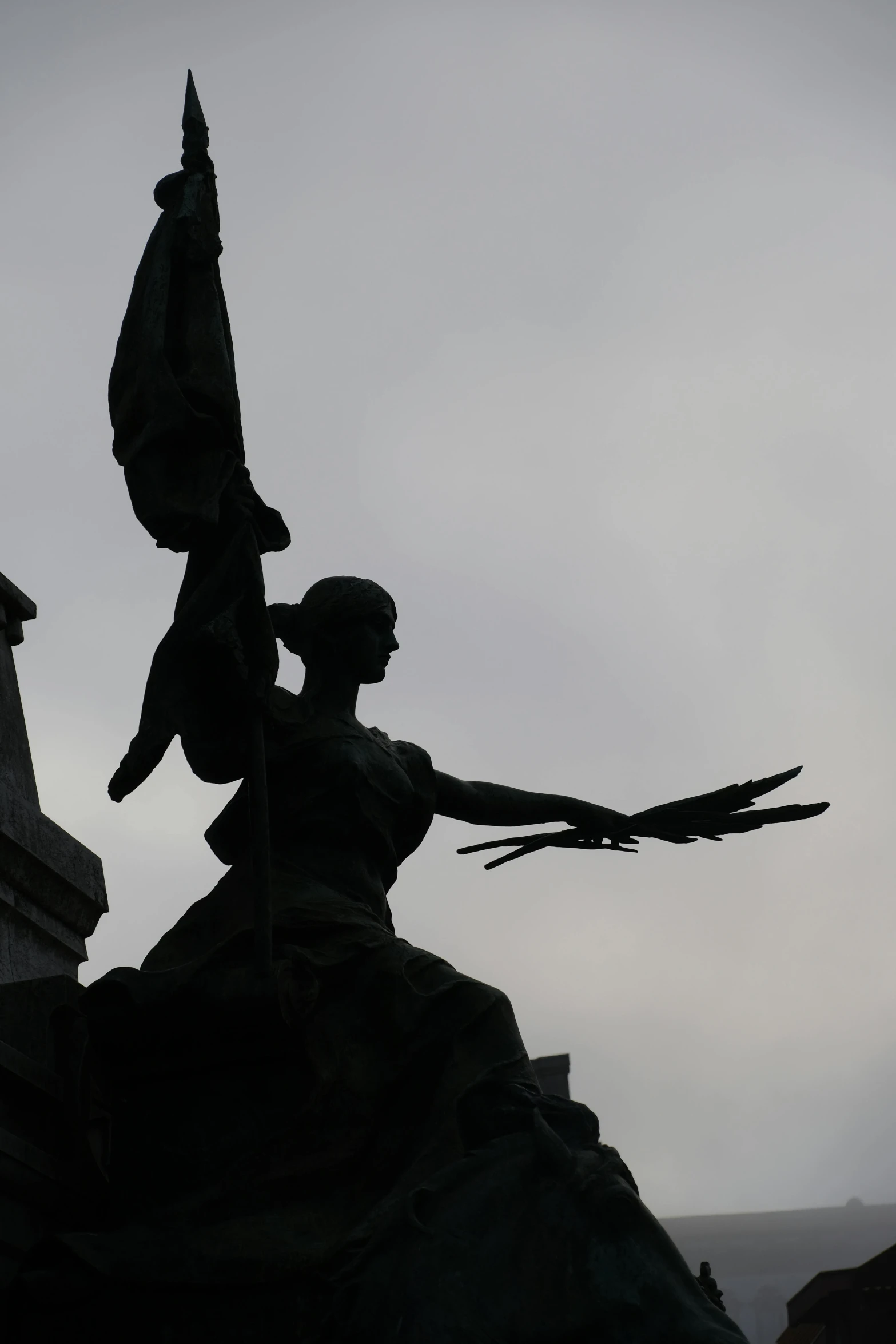 a statue holding the tail of a bird near a building