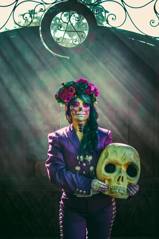 a woman in purple jacket and flowers holding a skull