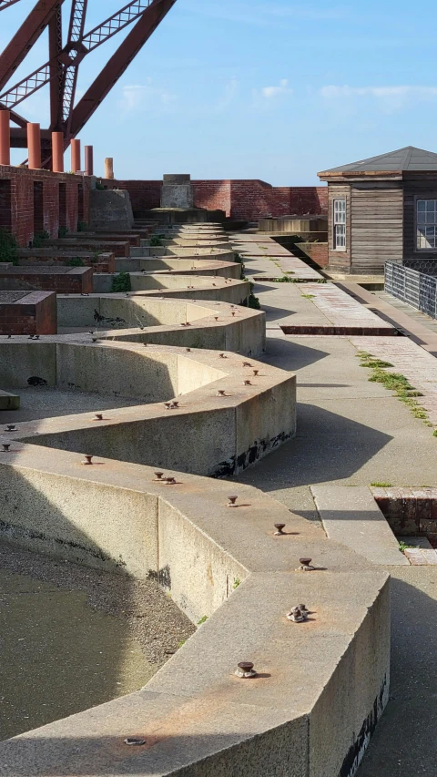 concrete benches are located in a long row