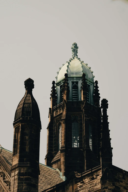 the top part of an ornate building against a sky background