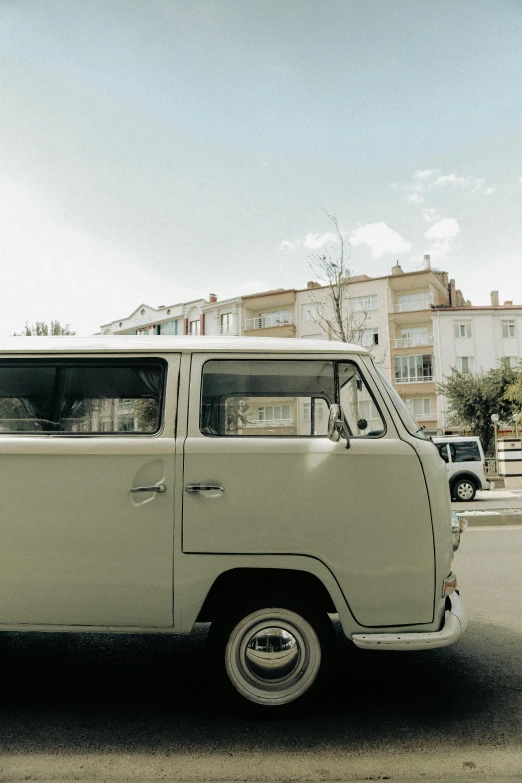 an old fashion car is parked in the middle of a street