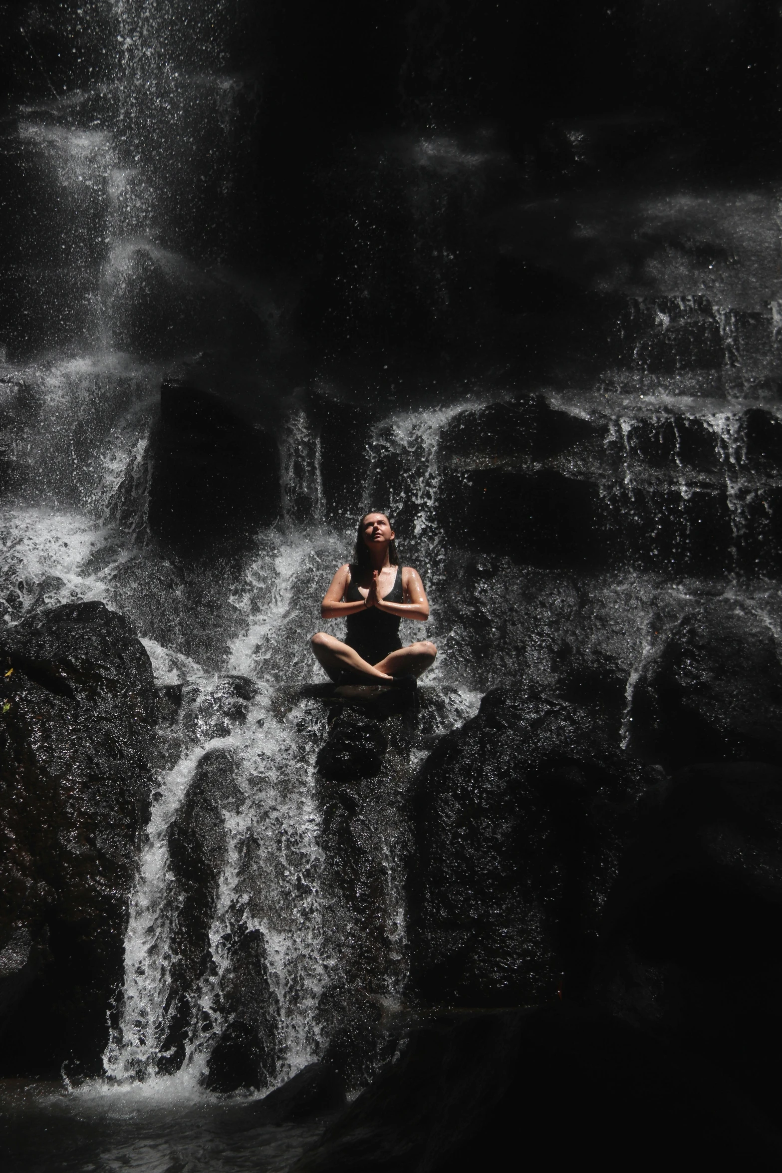 a man floating in water surrounded by rocks and falling rapids