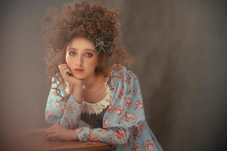 a woman that is sitting at a table