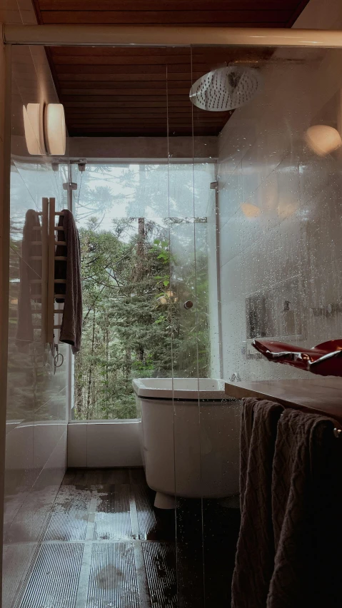 a bathroom with a large window showing the outside