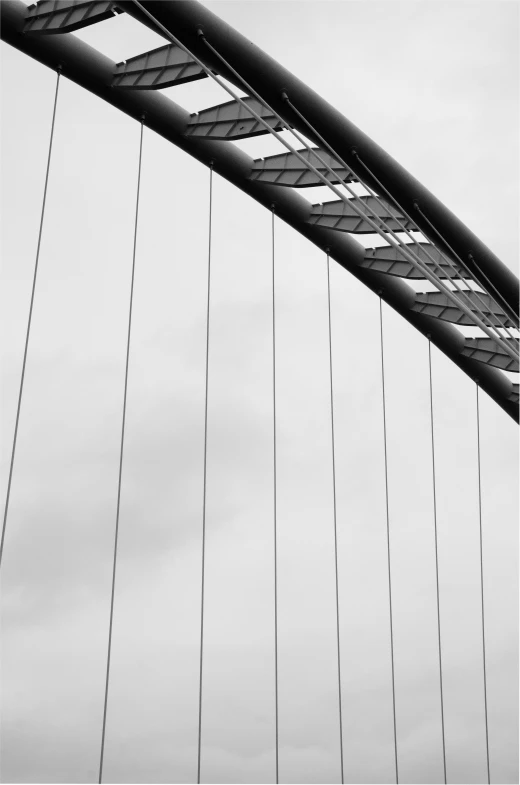 a black and white pograph of the underside of a bridge