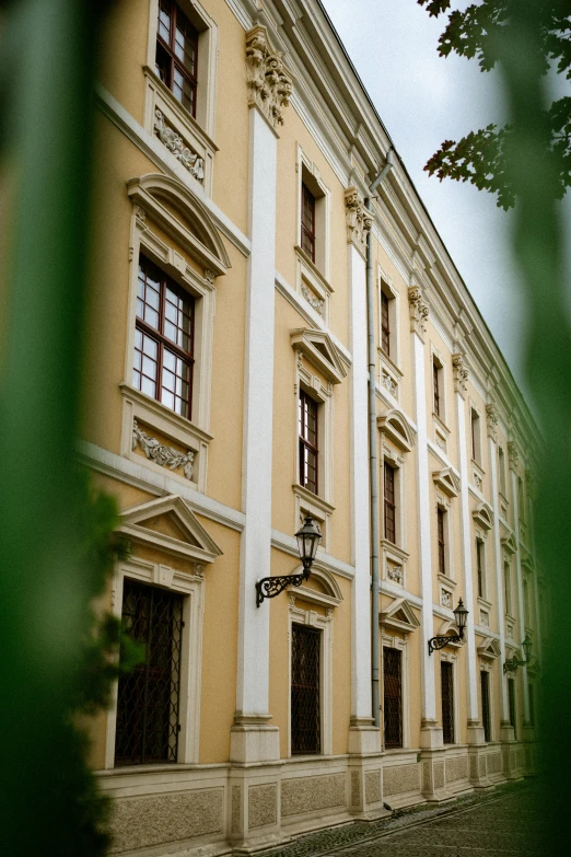 a yellow house is shown through a green window