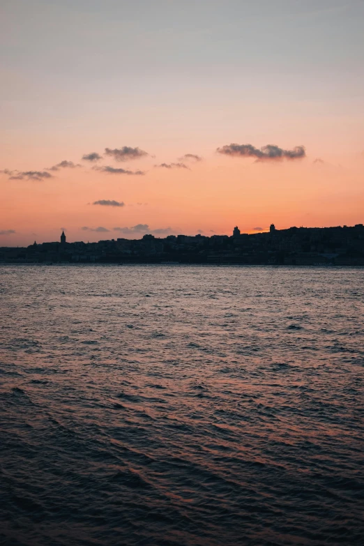 a body of water with boats on it during sunset