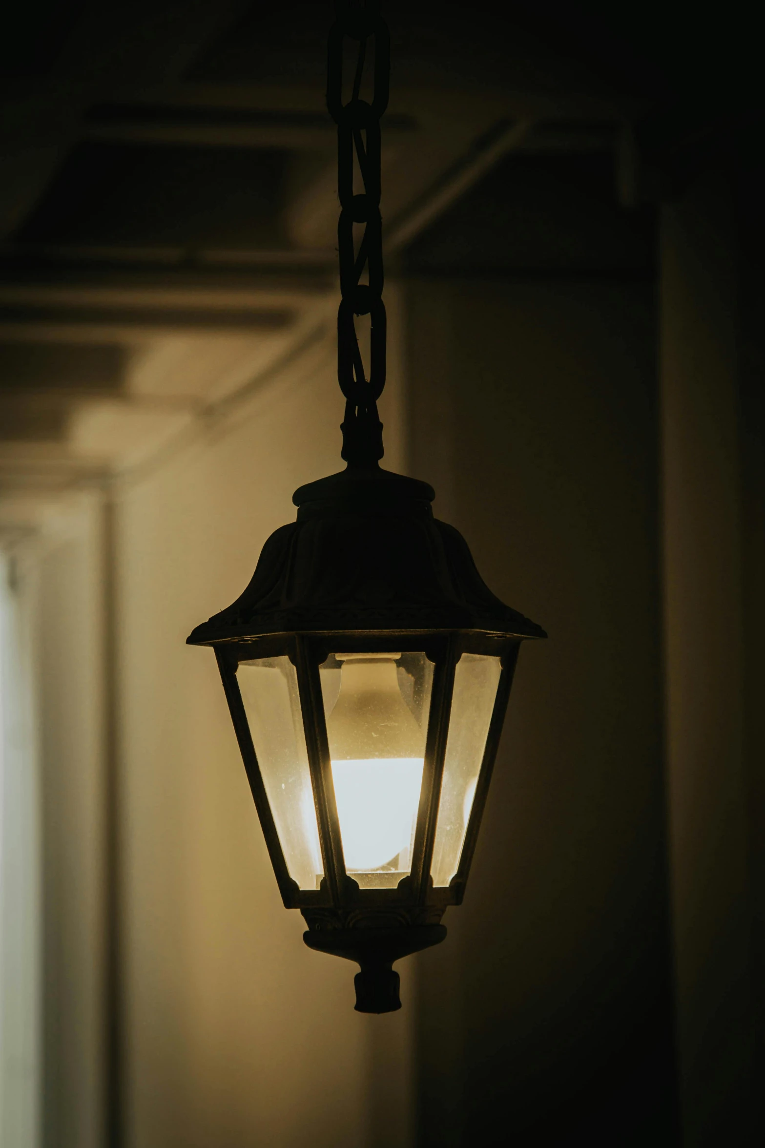 an old lantern fixture with one light turned on