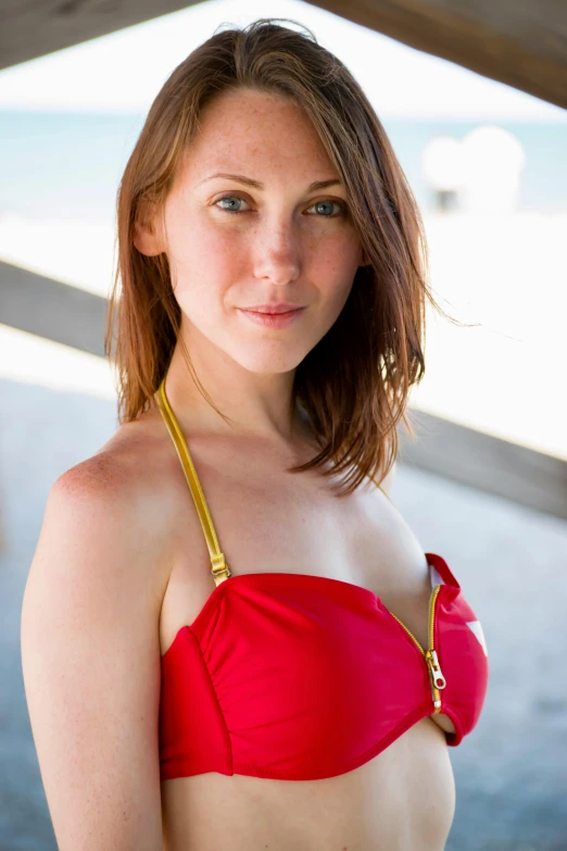 a pretty young woman in a red bikini posing for a po