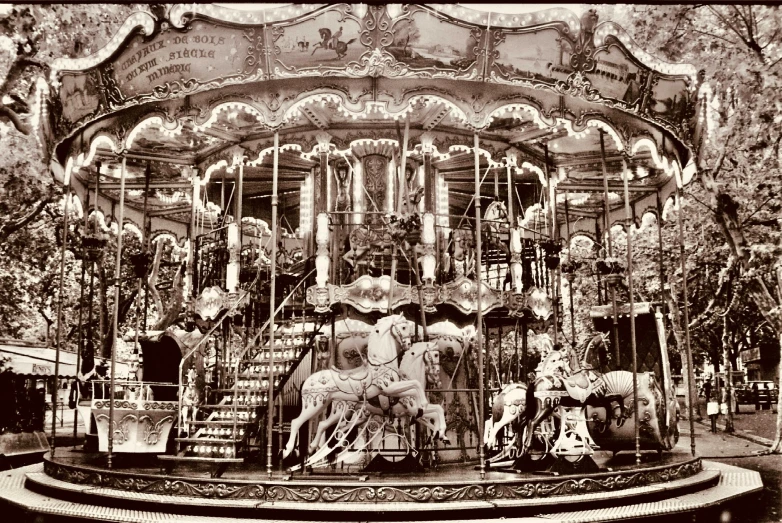 an old carousel with people and horses