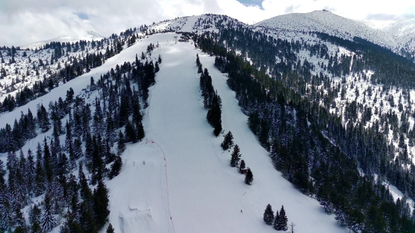 an aerial s of a ski lift that is at the top of a snowy mountain