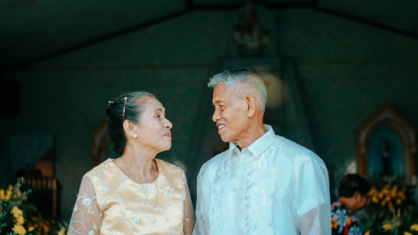 an elderly couple standing next to each other