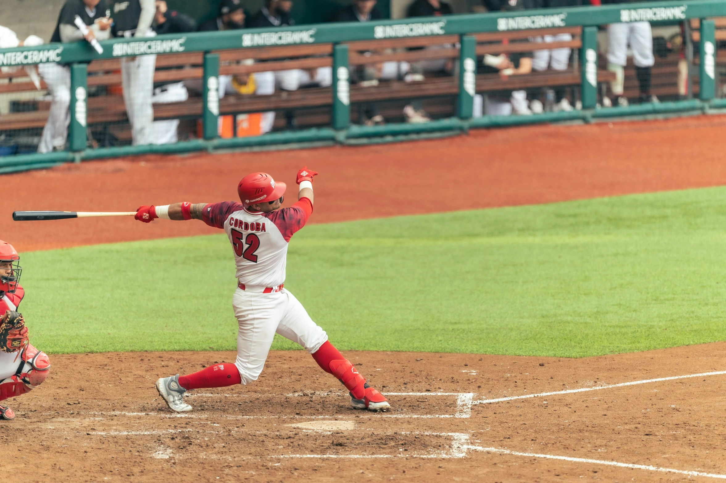 the batter is taking a swing during the baseball game