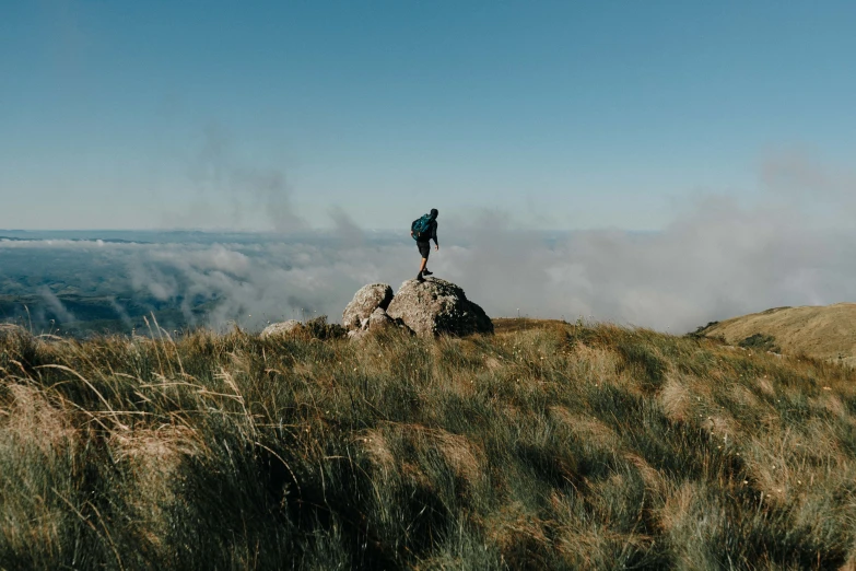 the person is standing on a rock formation