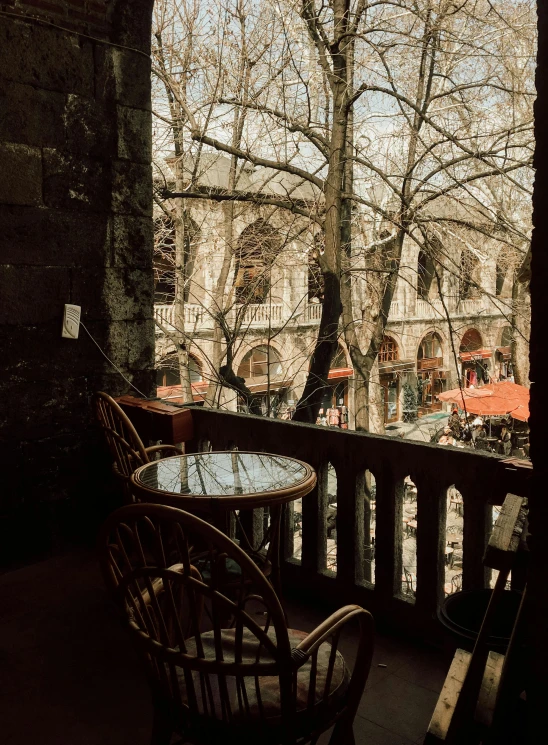 outside seating area with tables and umbrellas on the balcony