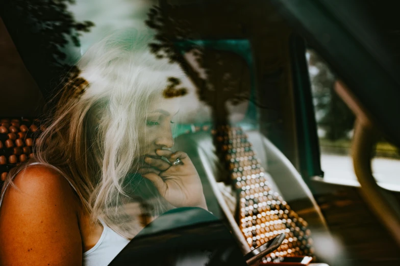 a woman is looking out of a bus window