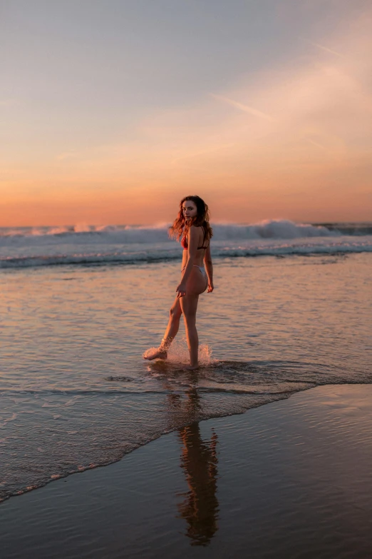 a person on the beach standing in the water