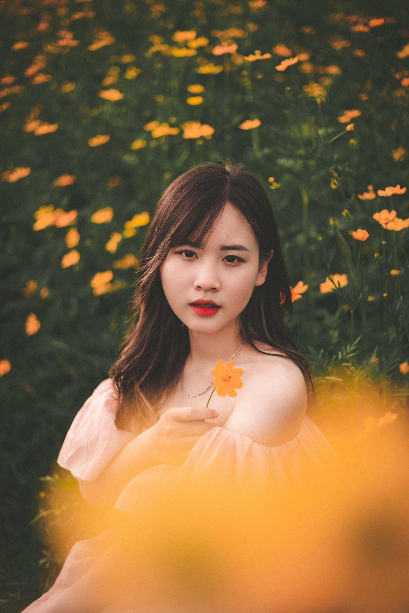 the girl poses for a po among wildflowers