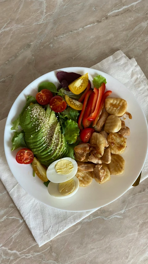 a white plate topped with vegetables and meat