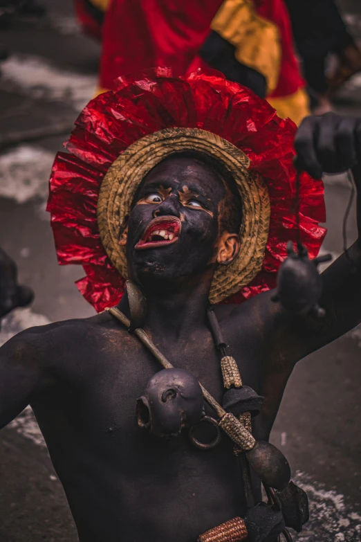 a man with makeup and painted body and black face