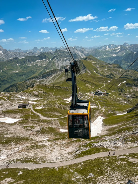 a chair lift on top of a grassy hill