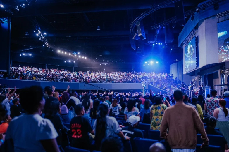 people are gathered inside a stadium to watch an event