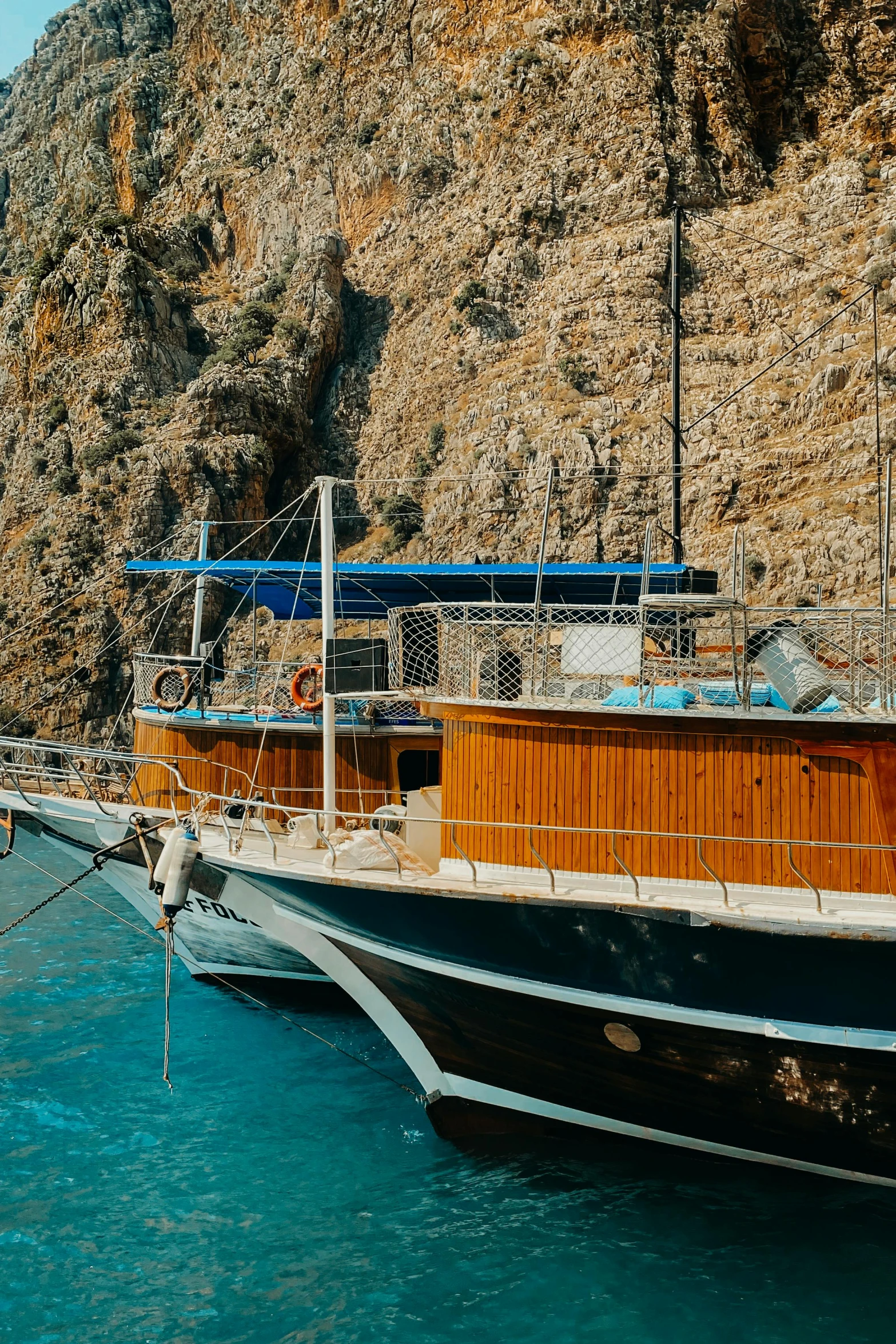 an old boat sits at a dock near mountains