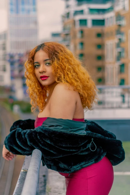 a woman with curly red hair wearing a pink outfit and green shoes